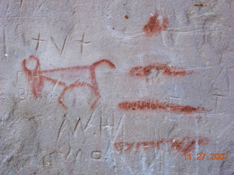 Red painted image similar to deer or pronghorn on a rock face.