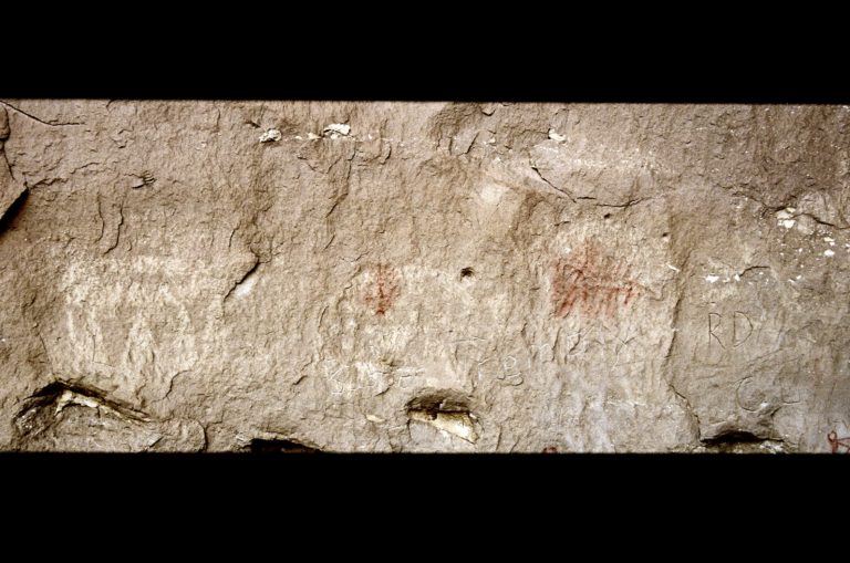 White Painted Shields, Picture Canyon with red symbols painted over the top.